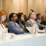 Speakers and delegates listening intently